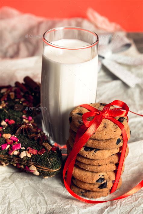 Milk And Cookies On White Background For Santa Claus