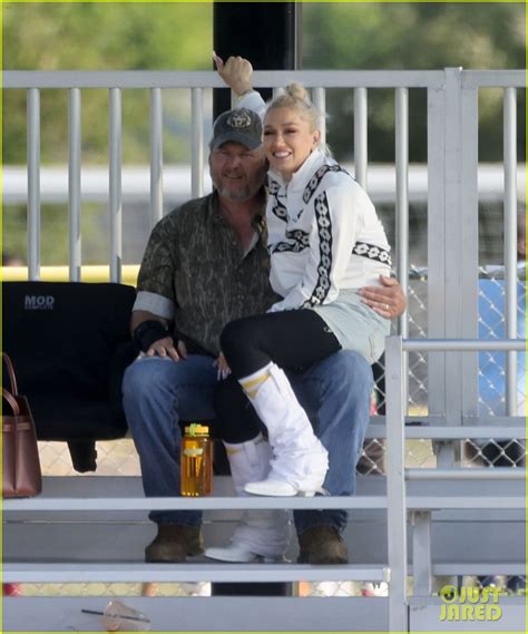 gwen stefani sits on blake shelton s lap shares a kiss while attending her son s football game