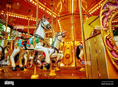 Carousel With Colorful Horses At Amusement Park Merry Go Round With