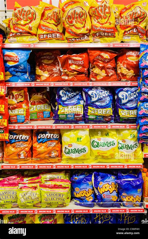 Packets Of Branded Snack And Crisps On Sale On The Shelves In A