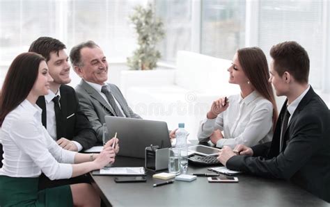 Business Colleagues Talking At Desk In The Office Stock Photo Image