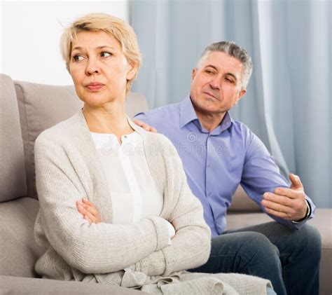 Irritated Mature Couple Quarreling At Home With Each Other Stock Photo Image Of Couple