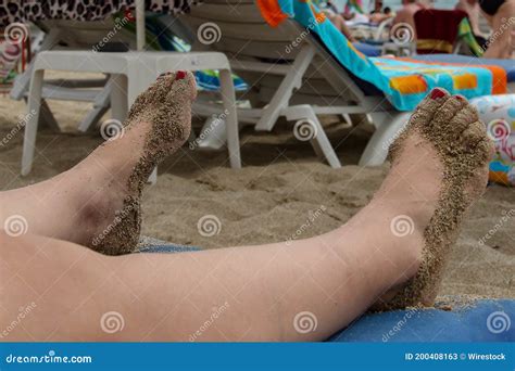 Feet Of A Woman Covered In Sand On The Beach Stock Image Image Of