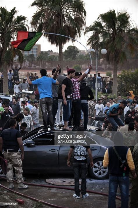 Libyans Wave Their Former National Flag Now Used By The Rebellion