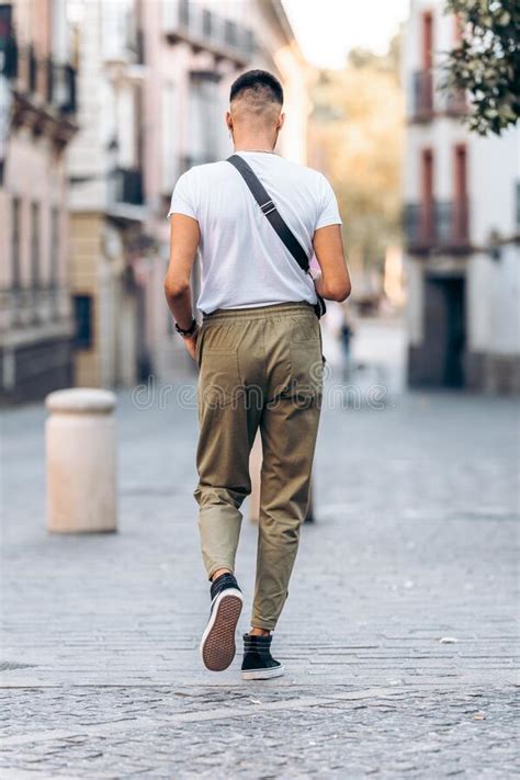 Man Walking Down The Street Dressed In Casual Clothing Stock Image