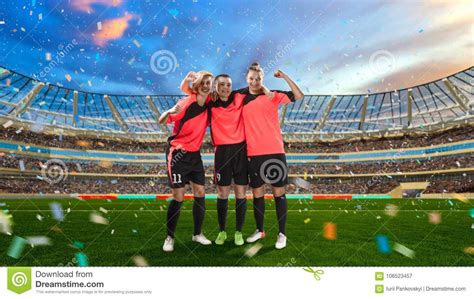 Three Female Soccer Players Celebrating Victory On Soccer Filed Stock