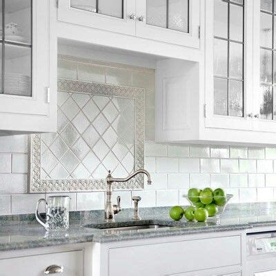 Maybe you would like to learn more about one of these? subway tile backsplash with pretty insert over sink (With ...
