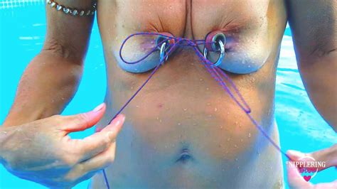 nippleringlover horny milf does self nipple bondage in pool pierced nipples bound with string