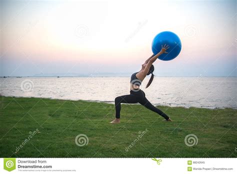 Silhouette Yoga Ball Yong Woman In The Beach Stock Image