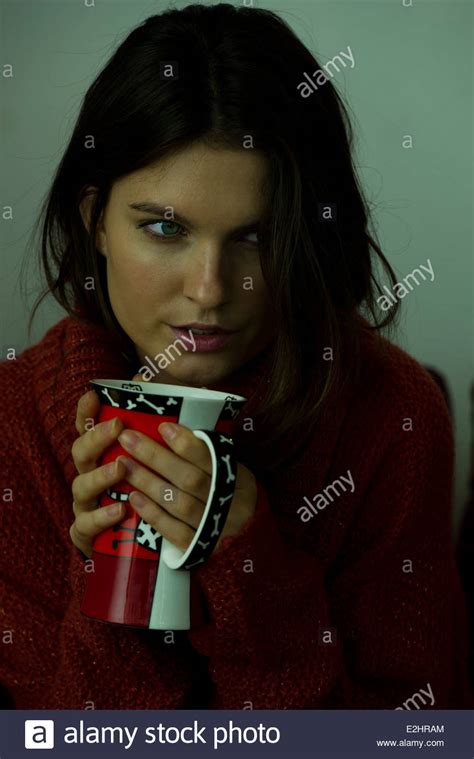 Woman In Sweater Holding Mug Portrait Stock Photo Alamy