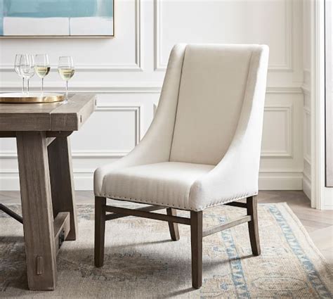 Our roomy and remarkable dining armchairs are the perfect crowning touch for your dining room, and we have both upholstered host chairs and wooden dining armchairs in a wide range of styles. Milan Slope Upholstered Dining Armchair | Pottery Barn