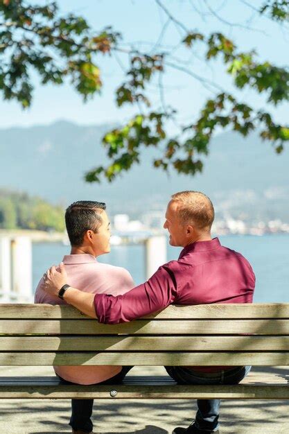 Premium Photo Middle Aged Couple Sitting On Bench Hugging Relaxing In Park Back View Outdoors