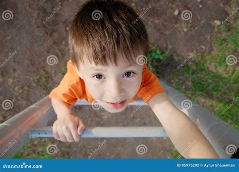 Boy Climbing Stairs And Playing Outdoors On Playground Children