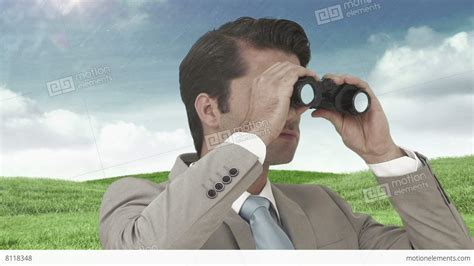 Businessman Looking Through Binoculars Against Green Field Stock