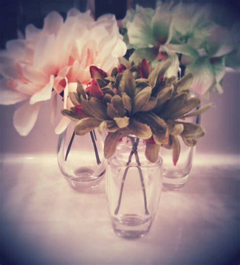 How to put store bought flowers in a vase. Pretty DIY idea to reuse perfume bottles: I bought these ...