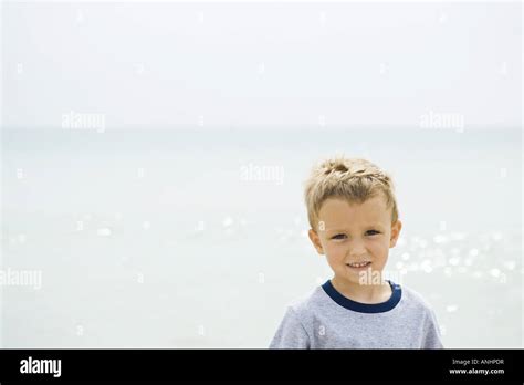 Young Boy At The Beach Smiling At Camera Portrait Stock Photo Alamy