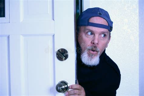Man Sneaking Into House From Doorway Stock Photo Image 11339720