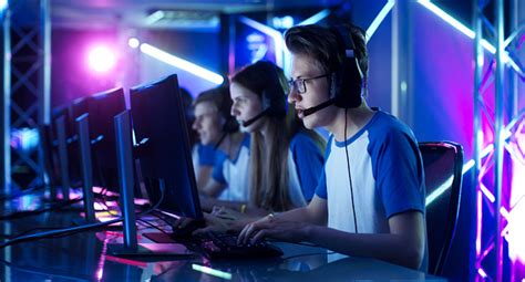 Team Of Teenage Gamers Play In Multiplayer Pc Video Game On A Esport