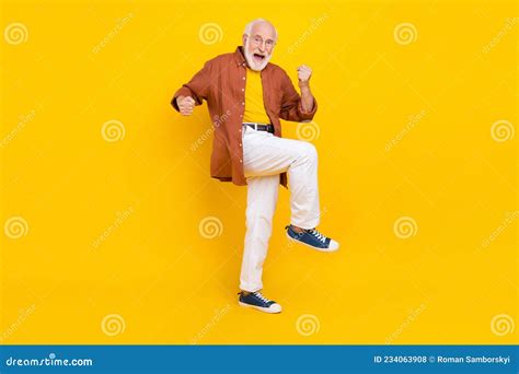 photo of lucky old man raise hands celebrate victory wear specs brown shirt pants shoes isolated