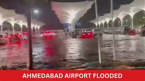 Watch Ahmedabad Airport Flooded Passengers Wade Through Knee Deep