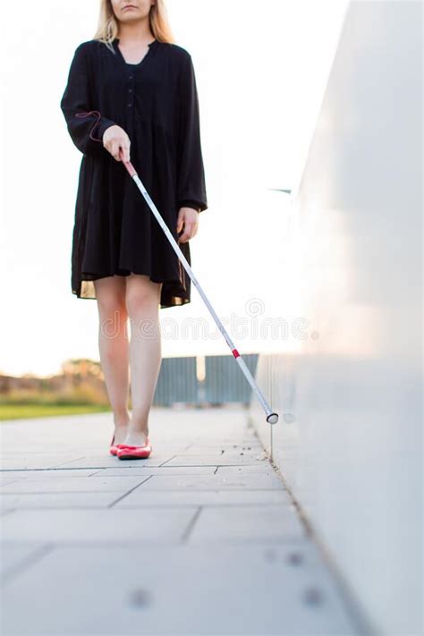 Blind Woman Walking On City Streets Using Her White Cane Stock Image