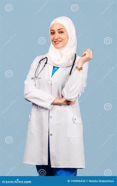 Portrait Of A Friendly Muslim Doctor Or Nurse Woman In Hijab With A Stethoscope In A White Coat