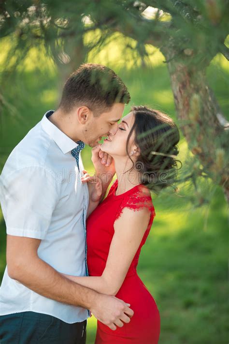 Happy Young Couple Kissing In Park Stock Image Image Of Cheerful