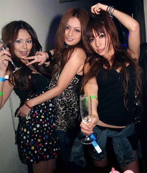 A lilac chinese top lined in gold with the middle of the chest cut out and held by a red ornate strap. Asian Night Club