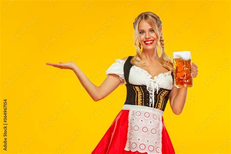 Young Sexy Oktoberfest Girl Waitress Wearing A Traditional Bavarian Or German Dirndl Serving
