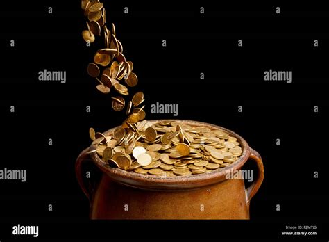 Gold Coins Falling In The Vintage Pot Stock Photo Alamy
