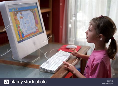 6 Year Old Girl Playing Online Computer Games Uk Stock