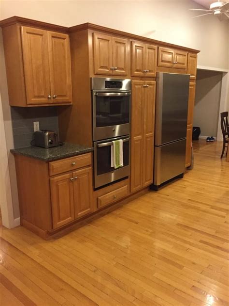 A splash of orange in the cabinetry and pendant light adds instant energy to the mostly neutral kitchen, which also features warm khaki cabinets and sage countertops. E-Design: 3 Painted Oak & Maple Kitchen Cabinet Projects ...