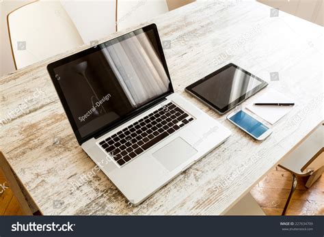 A Laptop Computer A Tablet Pc And A Smartphone On A Desktop Stock