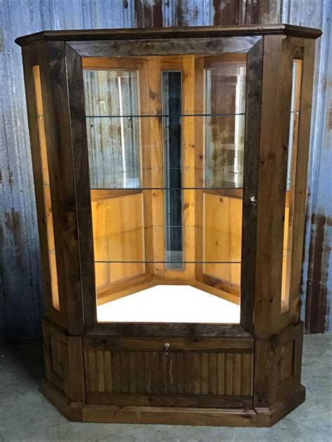 Six glass shelves can be adjusted to any level within your cabinet. Solid Pine Locking Light Corner Display Cabinet