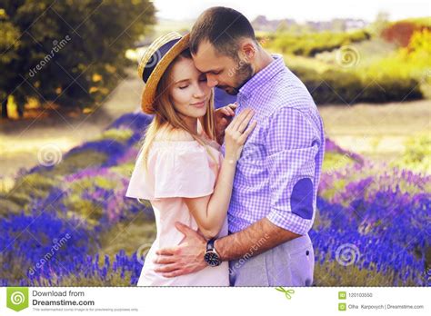 Cute Young Happy Couple In Love In A Field Of Lavender Flowers Enjoy A