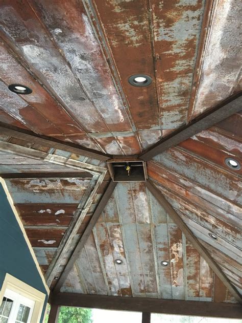 An Old Tin Roof With Holes In The Middle And Rust On Its Sides