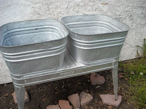 Two Metal Containers Sitting On Top Of Cement Blocks