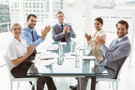 Business People Clapping Hands In Board Room Meeting Stock Photo