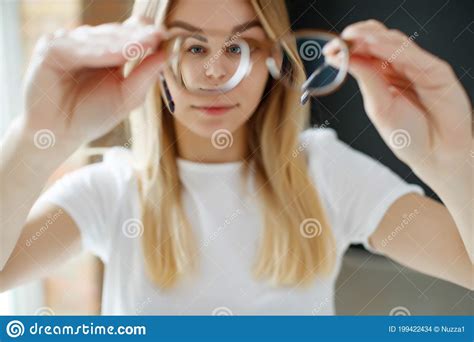 A Woman Has Vision Problems Squints When Trying To See Something Takes Off Her Glasses Is