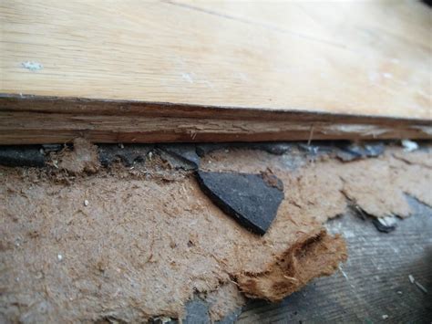 Is this asbestos? Flooring is glued to these two layers of unidentified ...