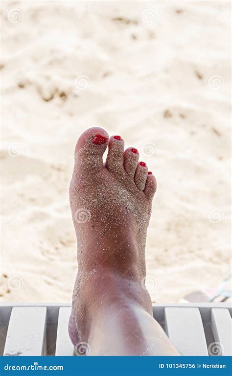 Woman Foot Leg Near Beach Sand Red Nails Resting And Relaxation Stock