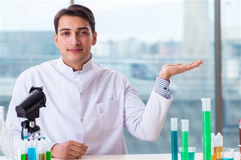 The Young Chemist Student Working In Lab On Chemicals Stock Photo