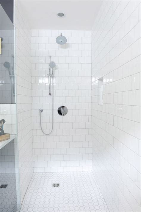 Maybe you would like to learn more about one of these? Walk-in shower features walls clad in white square tiles ...