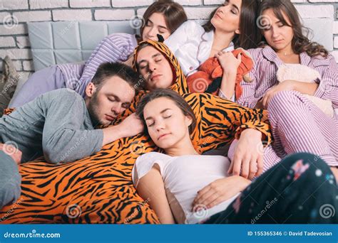 Sleeping Group Of Young People On The Bed Stock Photo Image Of