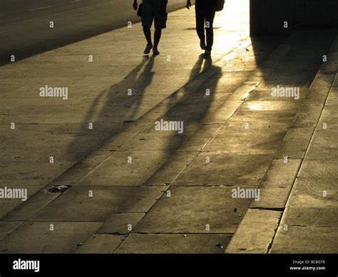 Two People Walking In Street Road In City Town Stock Photo Alamy