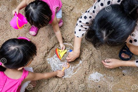 Asian Chinese Mum And Daughter Playing Sand Together Stock Image