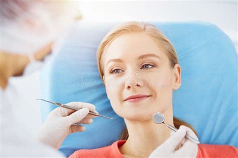 Happy Smiling Woman Is Being Examined By Dentist At Dental Clinic Healthy Teeth And Medicine