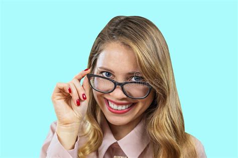 Portrait Of An Attractive Young Blonde With Glasses Looking Into The