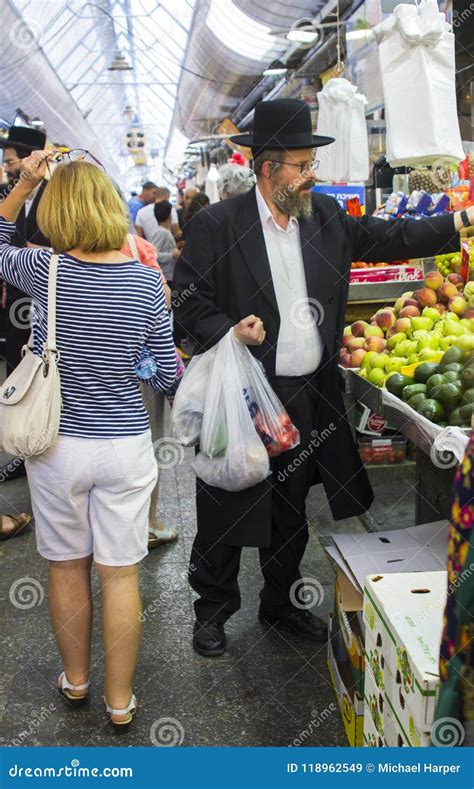 An Orthodox Chassidic Making A Purchase From A Stall In The Mahane