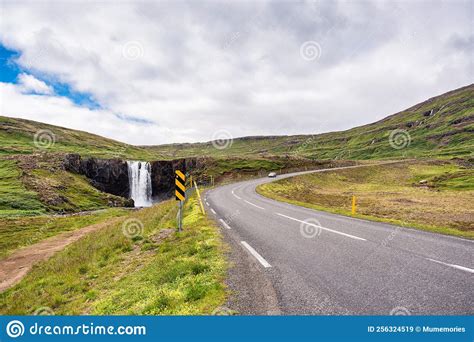 Gufufoss Waterfall And Car Driving On Highway In Fjord On Summer At
